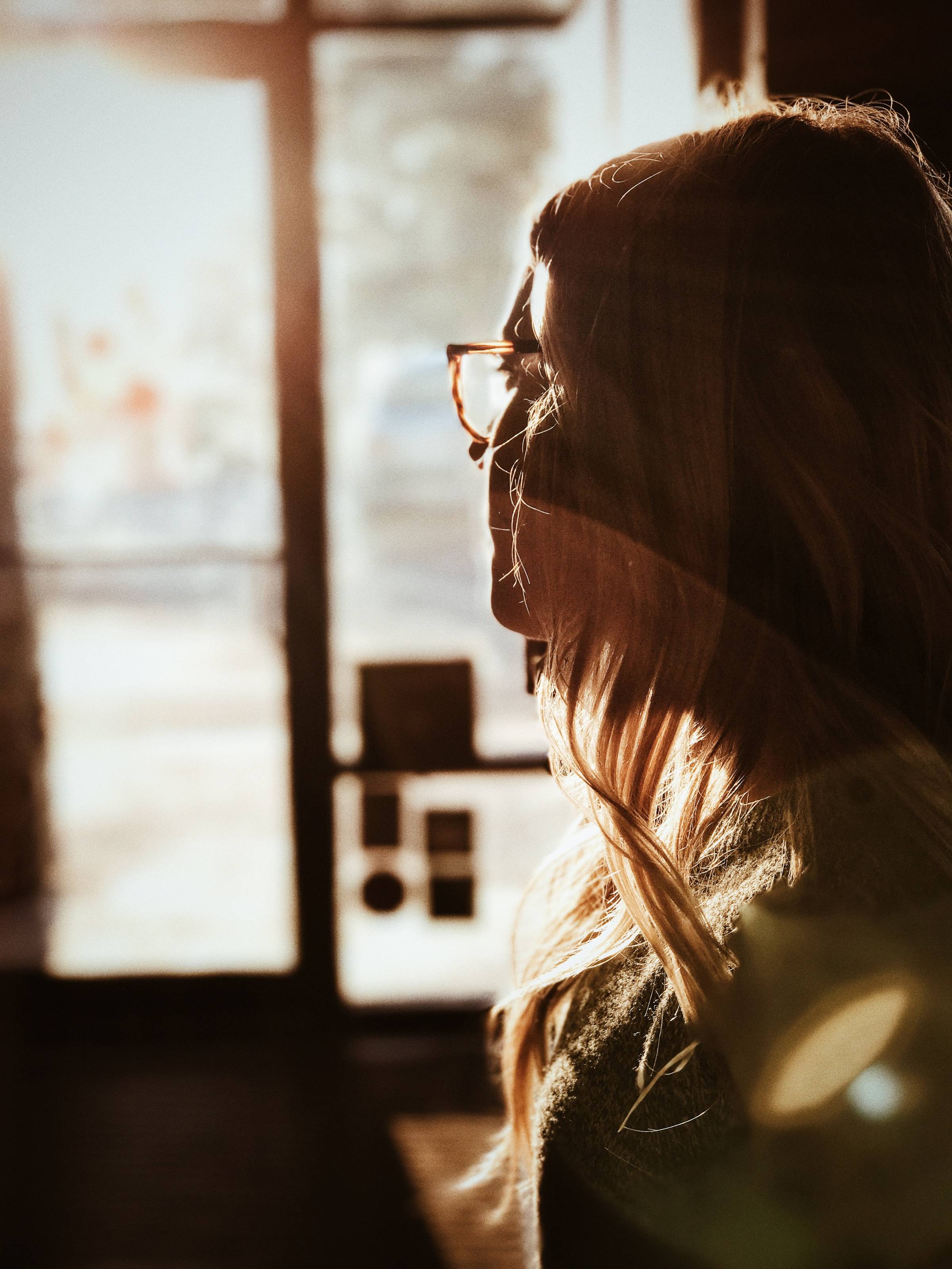 woman holding her hair during sunset