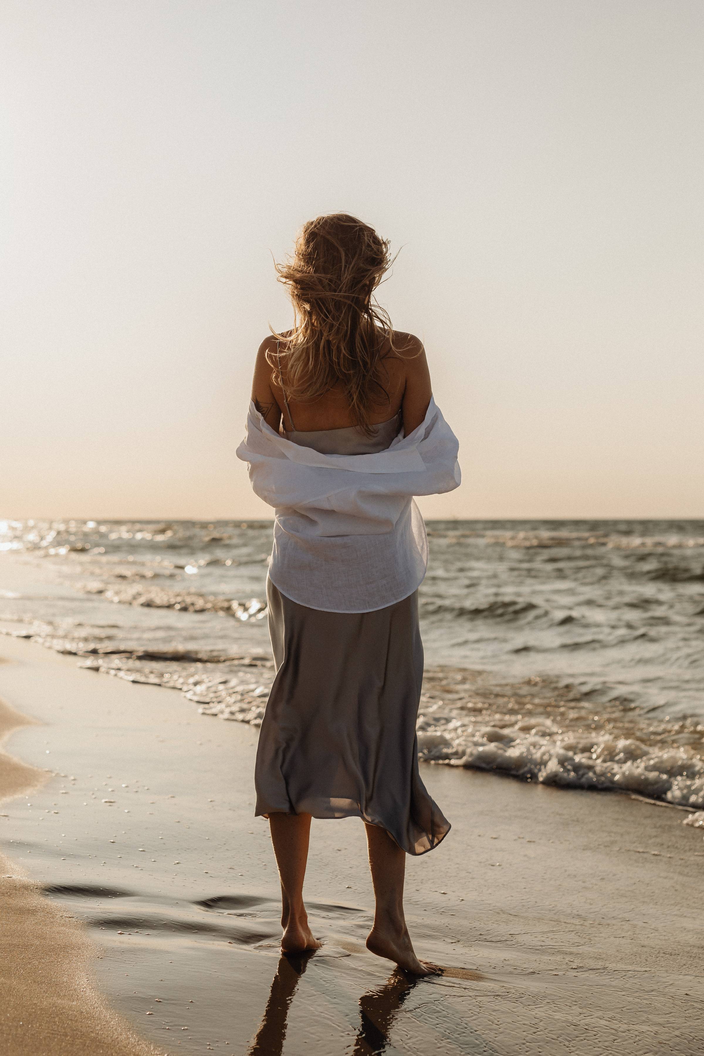 woman holding her hair during sunset