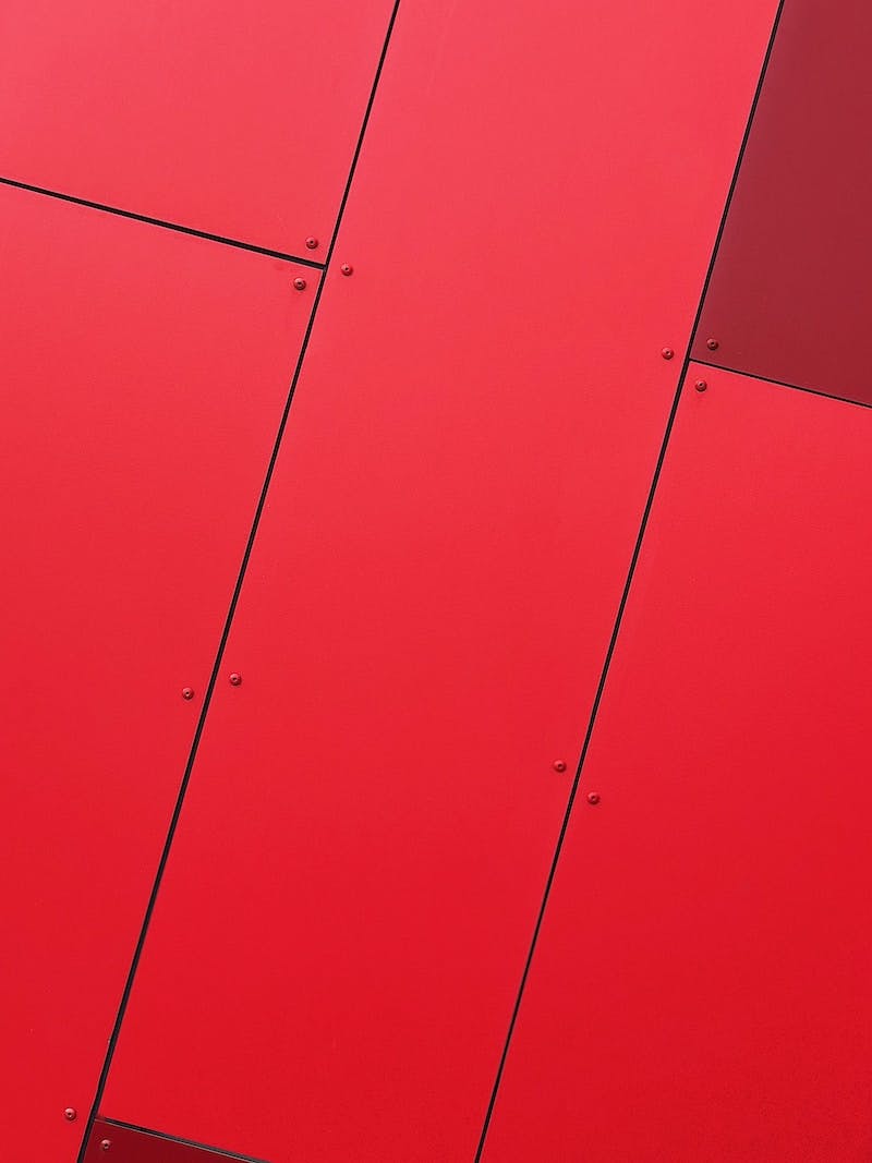 Close-up of a wall made of bright red metal panels