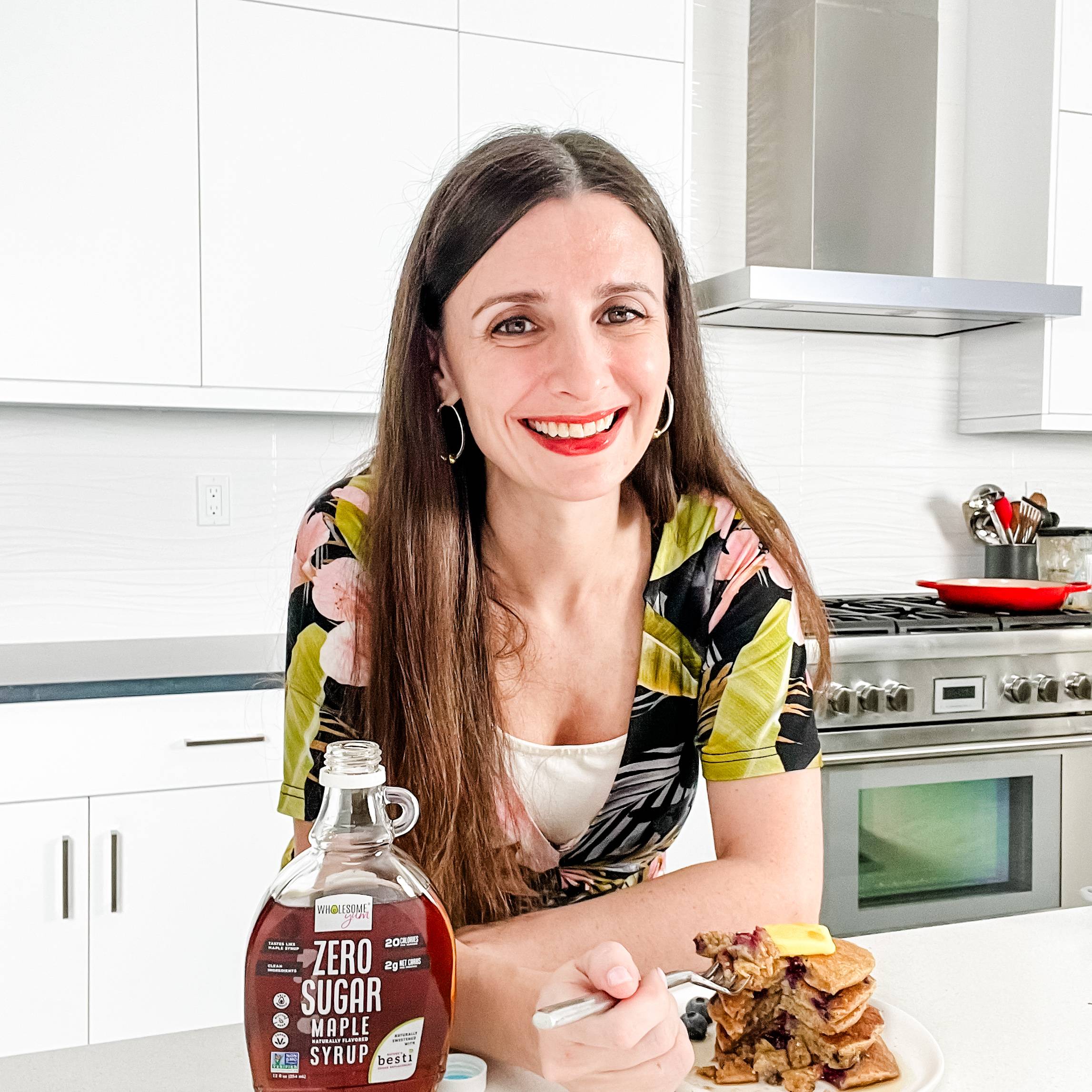 Maya eating pancakes with Wholesome Yum Maple Syrup.