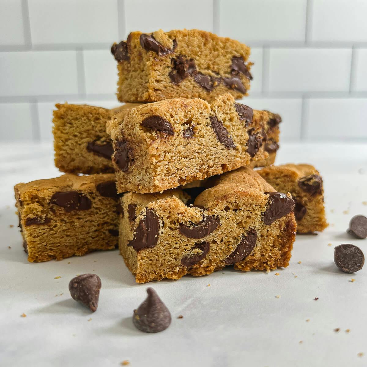 Chocolate Chip Cookie Bars stacked on a counter.