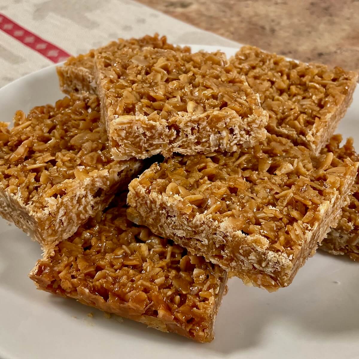 British flapjacks stacked on a white plate.