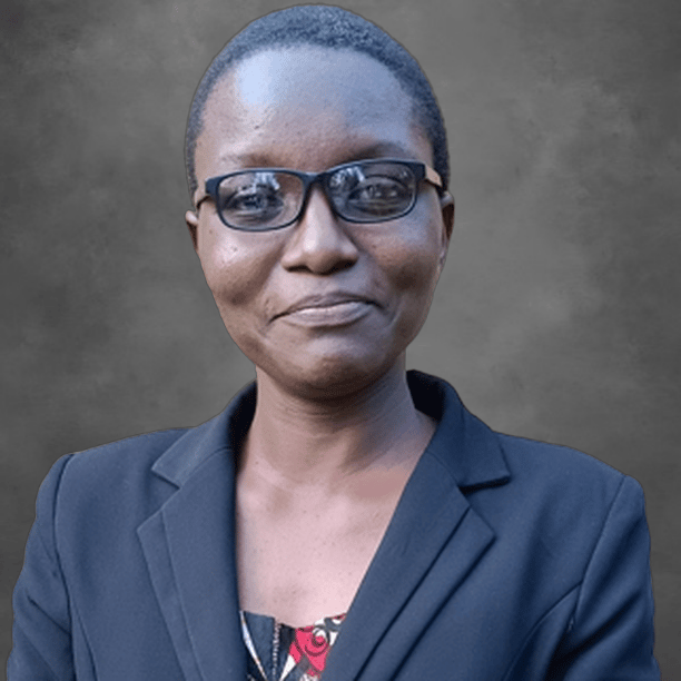 Sheba Ayinzabyonna - Short hair, black frame glasses, wearing a black jacket.