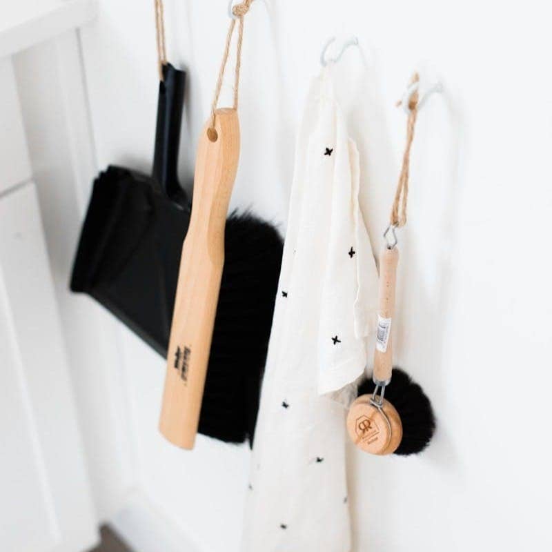 three black and brown bathroom cleaning tools