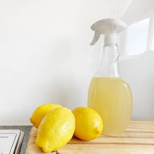 yellow lemon fruit beside clear glass bottle