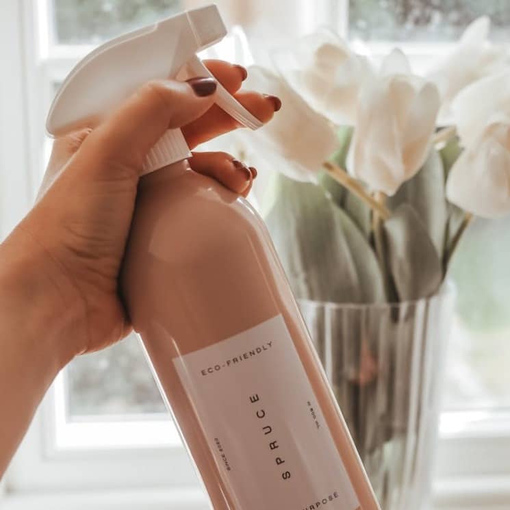 person holding a brown plastic bottle