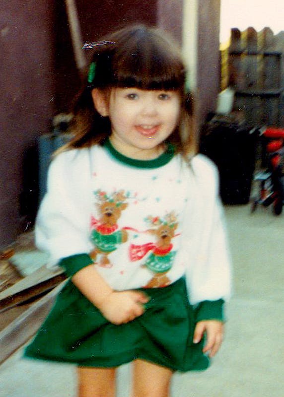 Kat Vancil in 1989 in a green & white holiday dress decorated with 2 reindeer