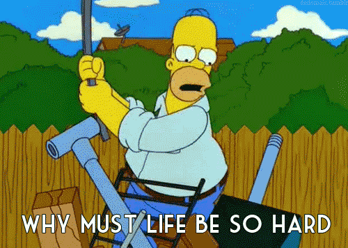 Angry Homer Simpson GIF from The Simpsons - In a yard, Homer wields a tire iron, angrily beating on various pipes and equipment, shouting, "Why must life be so hard," which appears as text.