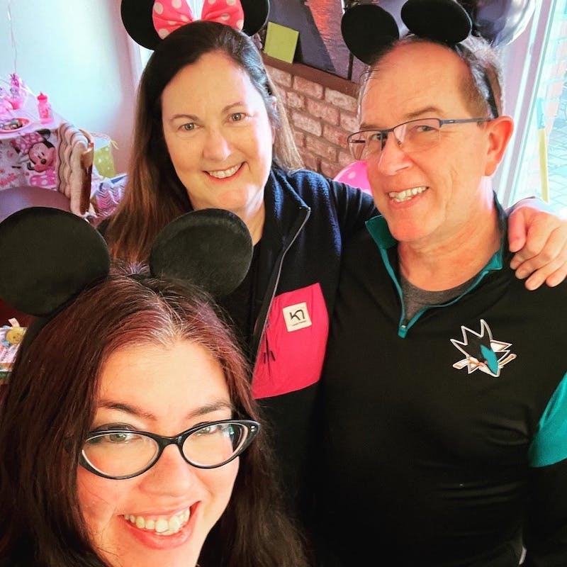Kat Vancil and Maureen and Bob Dillman sporting Mickey Mouse ears at a birthday party