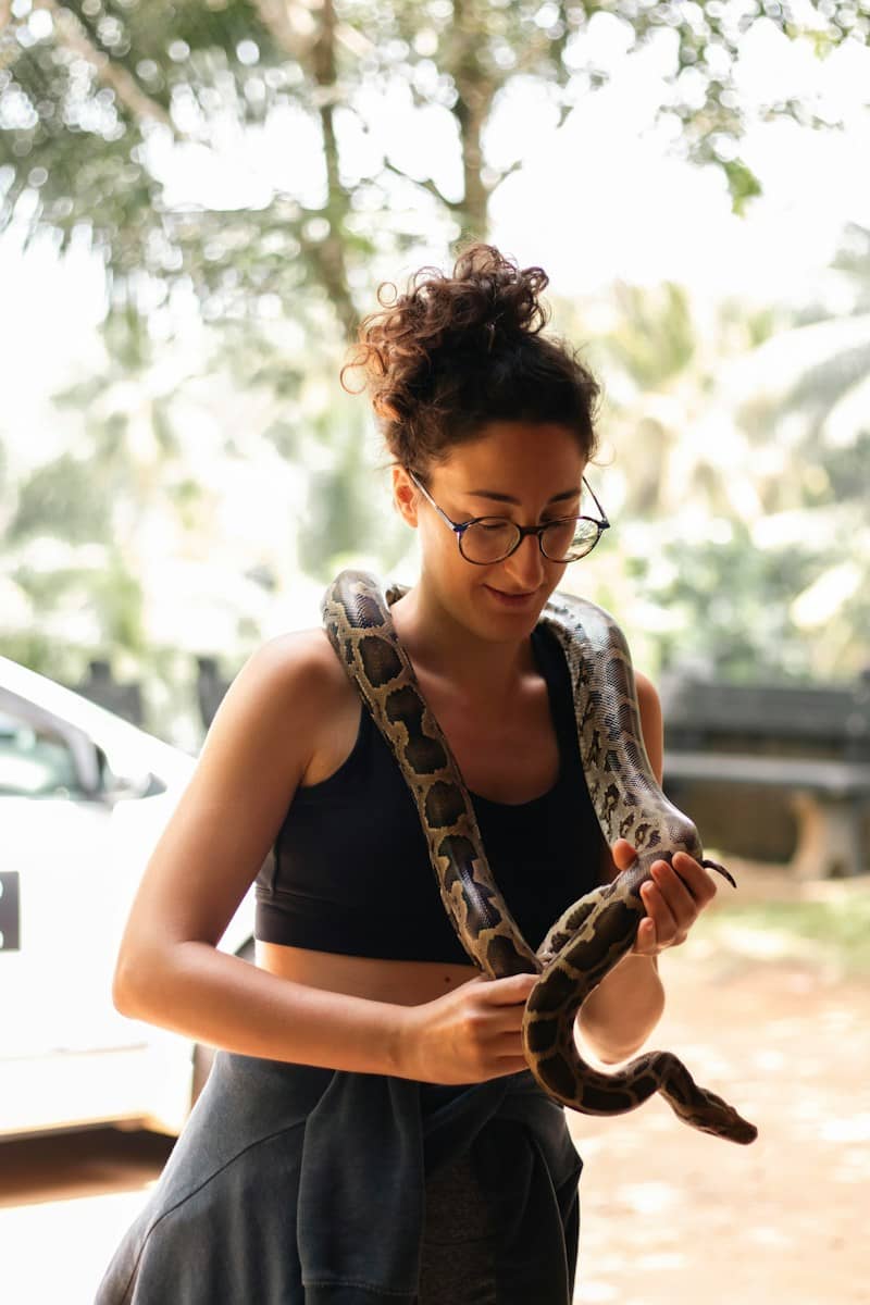 Woman with a snake around her neck