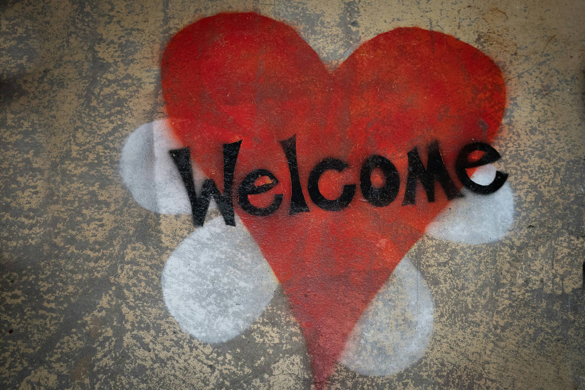 Neon welcome sign, bright and purple.