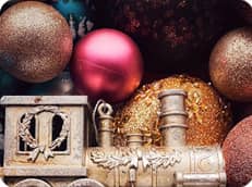 A medium size colorful thumbnail of Christmas style with a golden toy train and 5 Christmas spheres