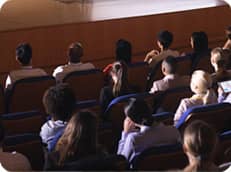 People sat and listening to the MC that is giving a conference