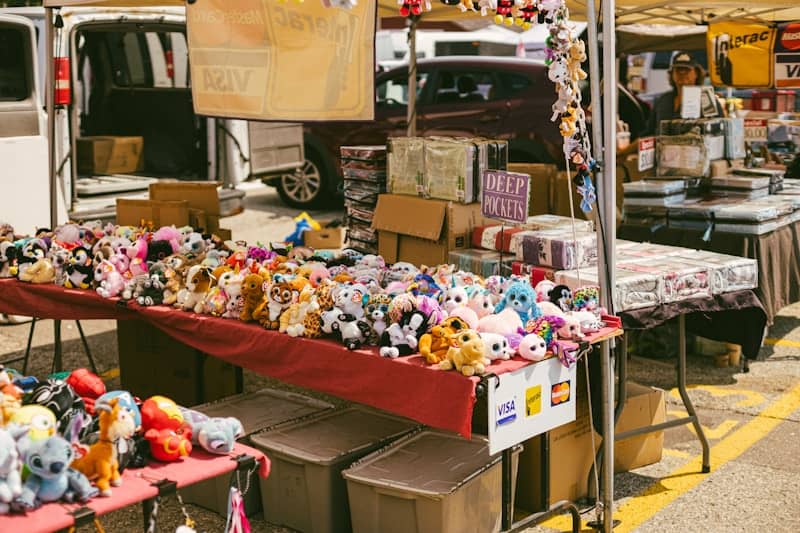 Stuffed animals for sale at an outdoor market.