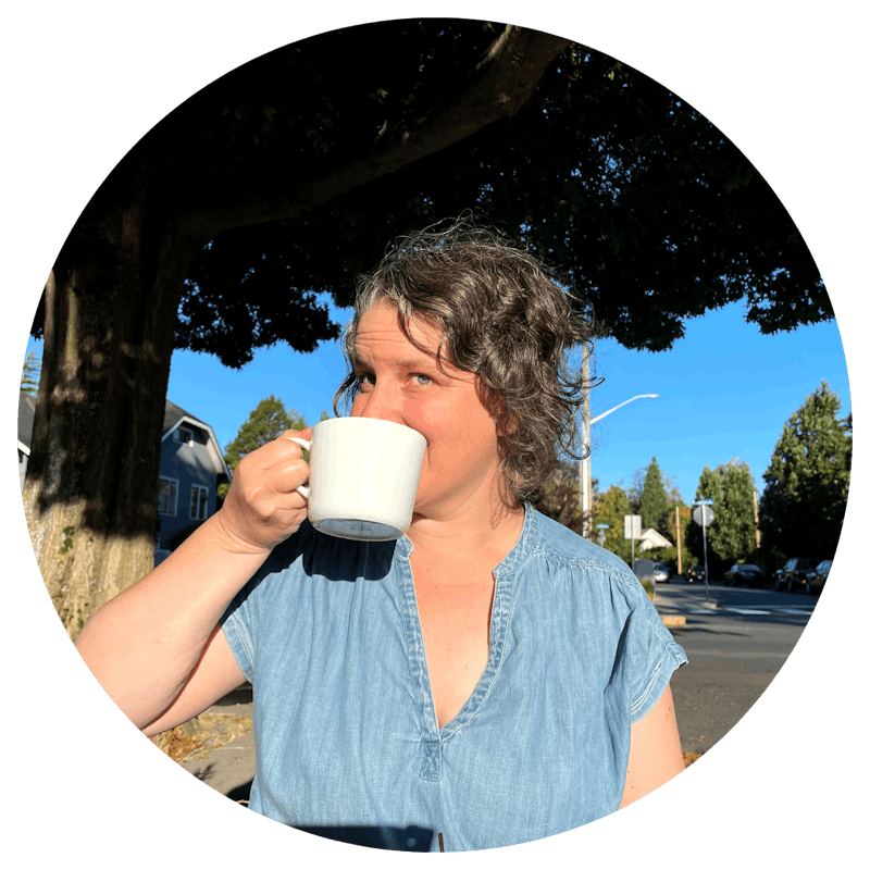 Woman with curly hair drinking coffee in the sunshine.