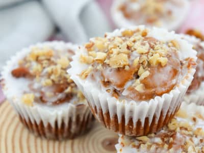 Close up of muffins with a glaze and walnuts on top