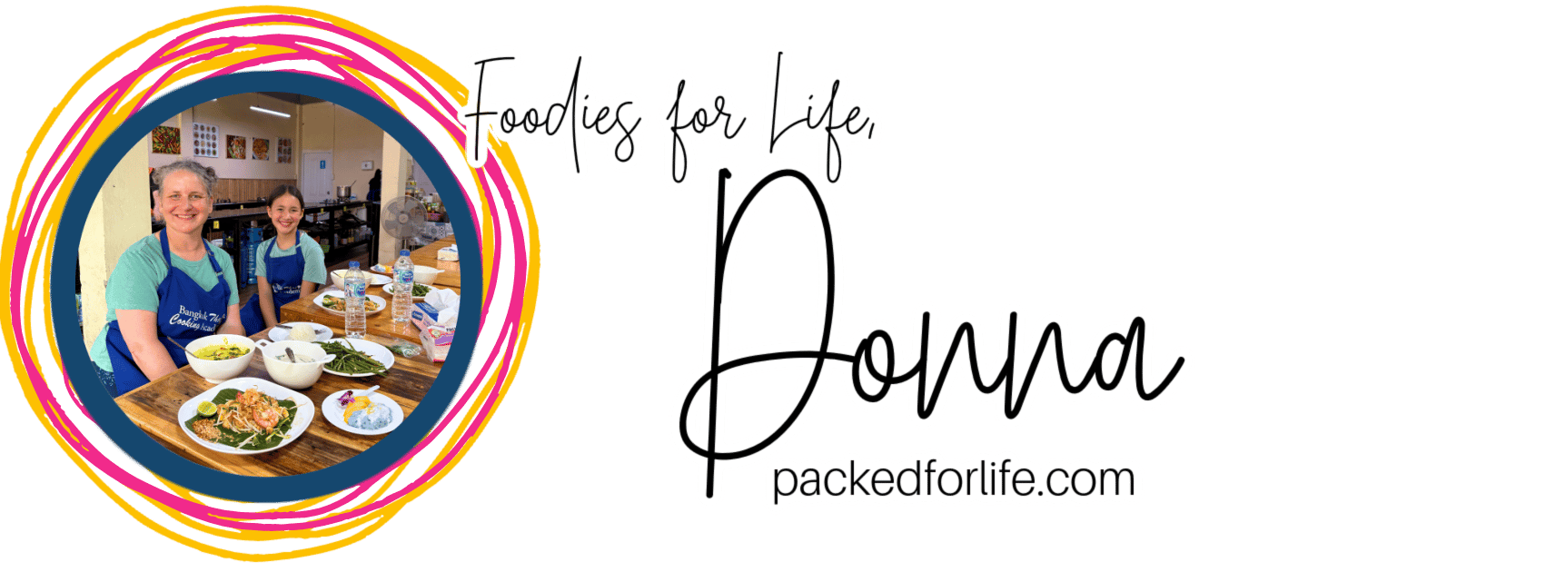 Mom and tween daughter wearing aprons are seated at a table with Thai food dishes in front of them during a Thai food making workshop. 