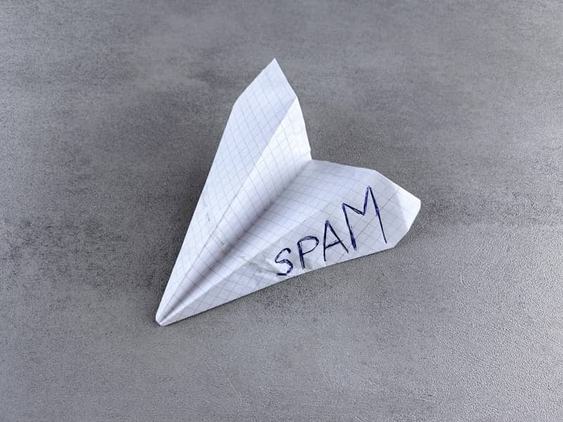 a paper airplane with the word spam written on it