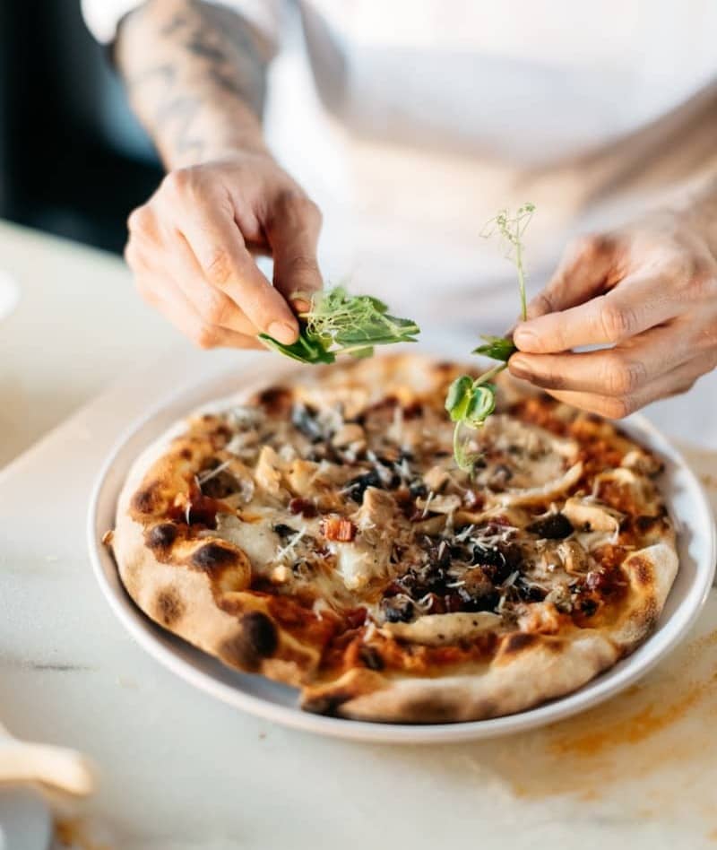 person preparing pizza