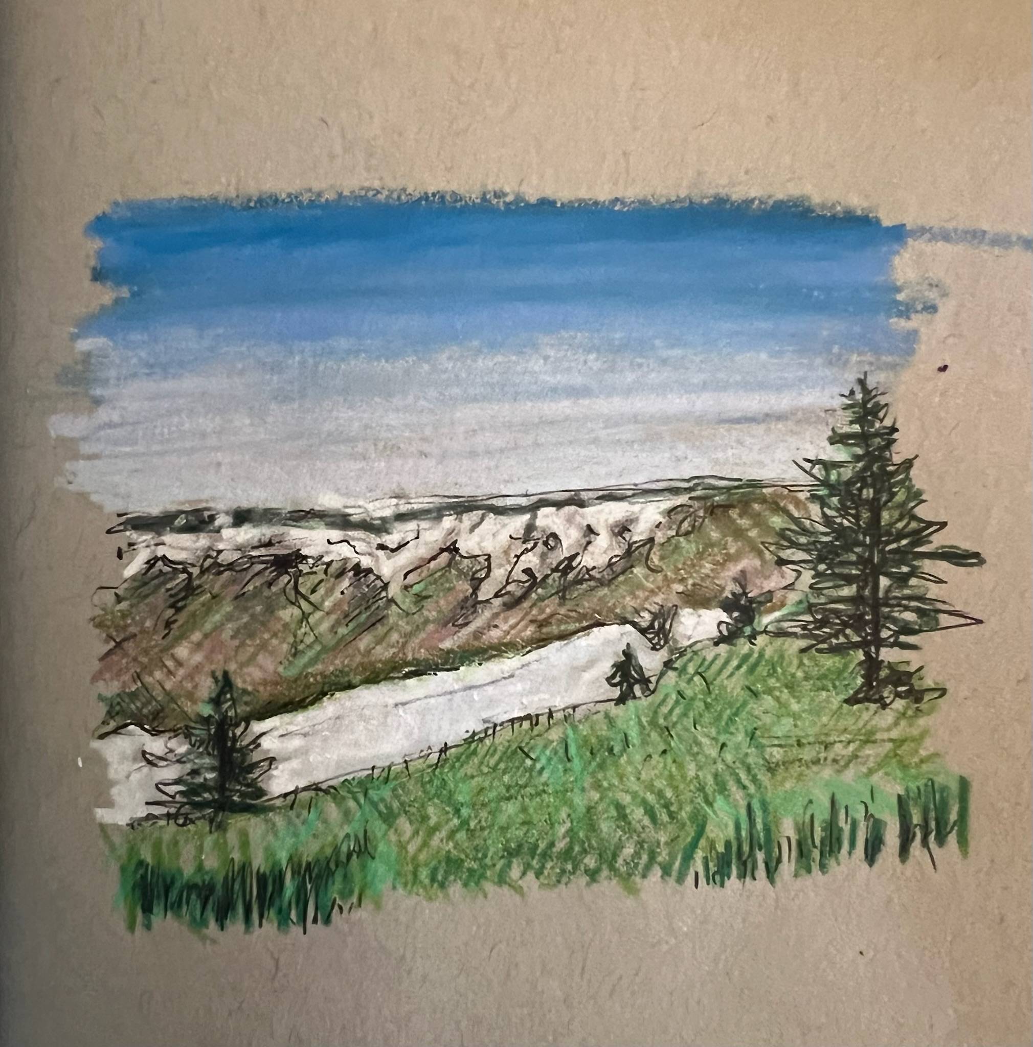 **Alt Text:**  A small mixed-media landscape sketch on tan paper depicting a winding pale path cutting through green grass and rolling hills. Sparse evergreen trees frame the scene, with one larger tree standing on the right. Beyond the hills, a distant horizon stretches beneath a soft blue sky that fades into white near the horizon. Loose ink lines and textured shading give the drawing an expressive, sketchbook-like quality.