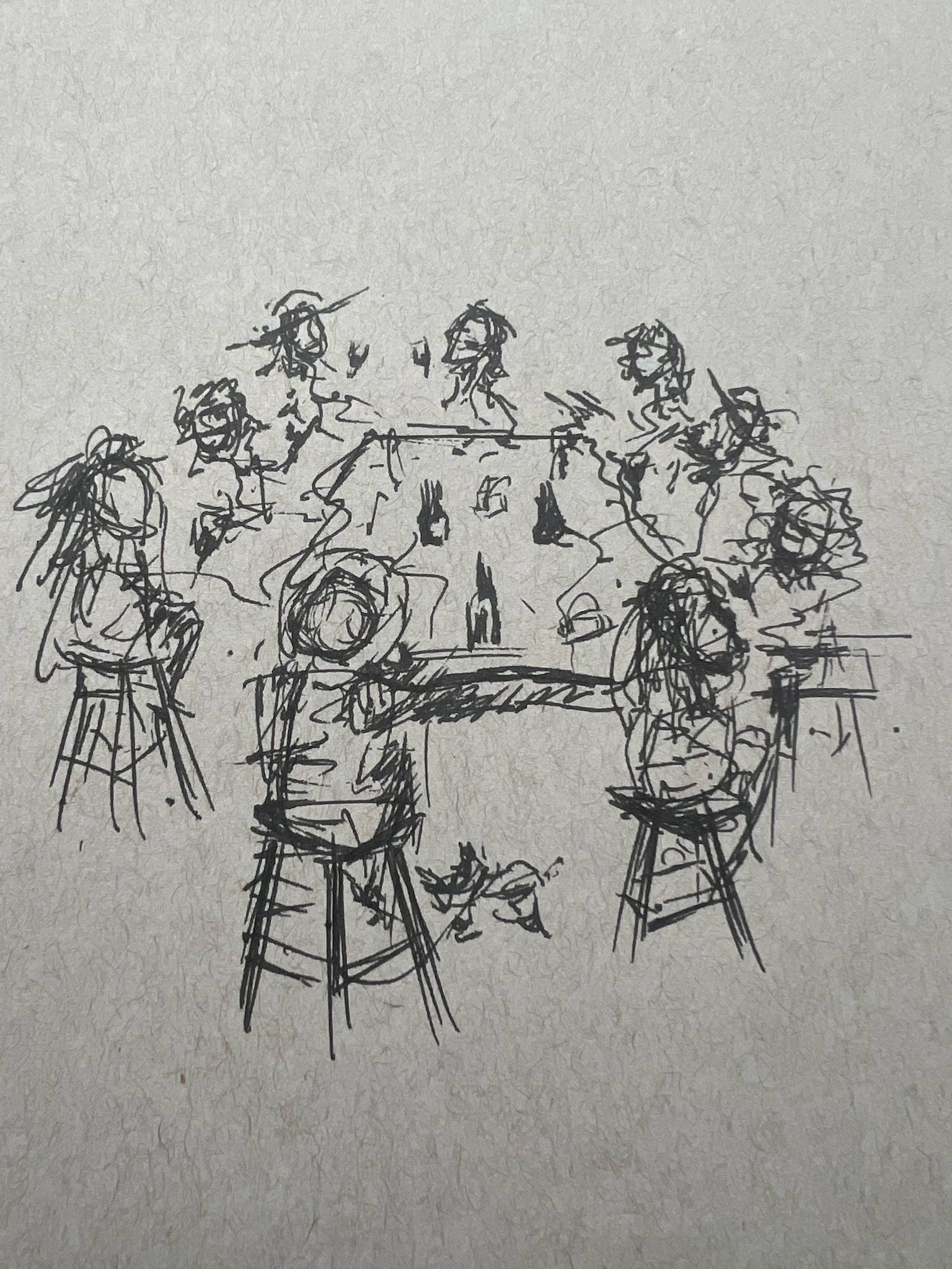 Alright, here you go — clean, detailed, and not written like a robot having an existential crisis:  **Alt Text:** A loose, sketchy black-ink drawing of a group of people gathered around a large table. The figures are minimally detailed, with quick, scribbled lines suggesting heads, arms, and gestures. Two people sit in the foreground on tall stools, facing the table, while several others form a semicircle around the back. Bottles or glasses sit on the table, and a small object or crumpled item lies on the floor near the front stools. The scene has the feel of a casual gathering or meeting, with lively, animated conversation implied by the scribbled motion lines and expressive poses.
