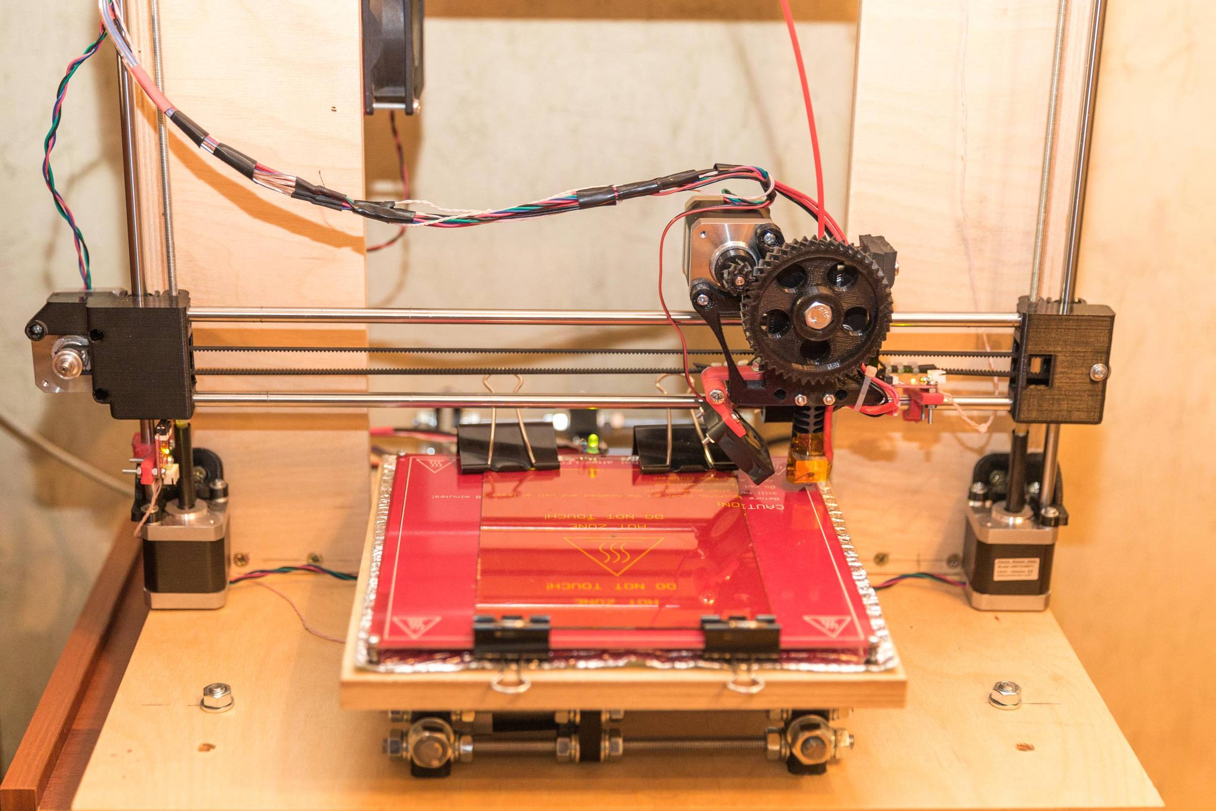 3D printer creates an orange plastic sheet
