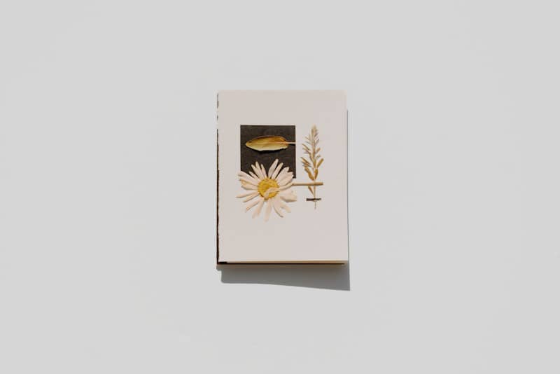 A small white card displays dried flowers.
