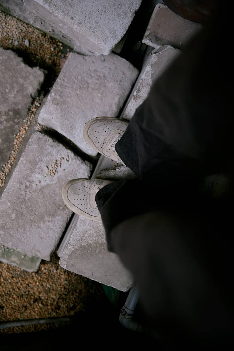 Person standing on rough concrete blocks.