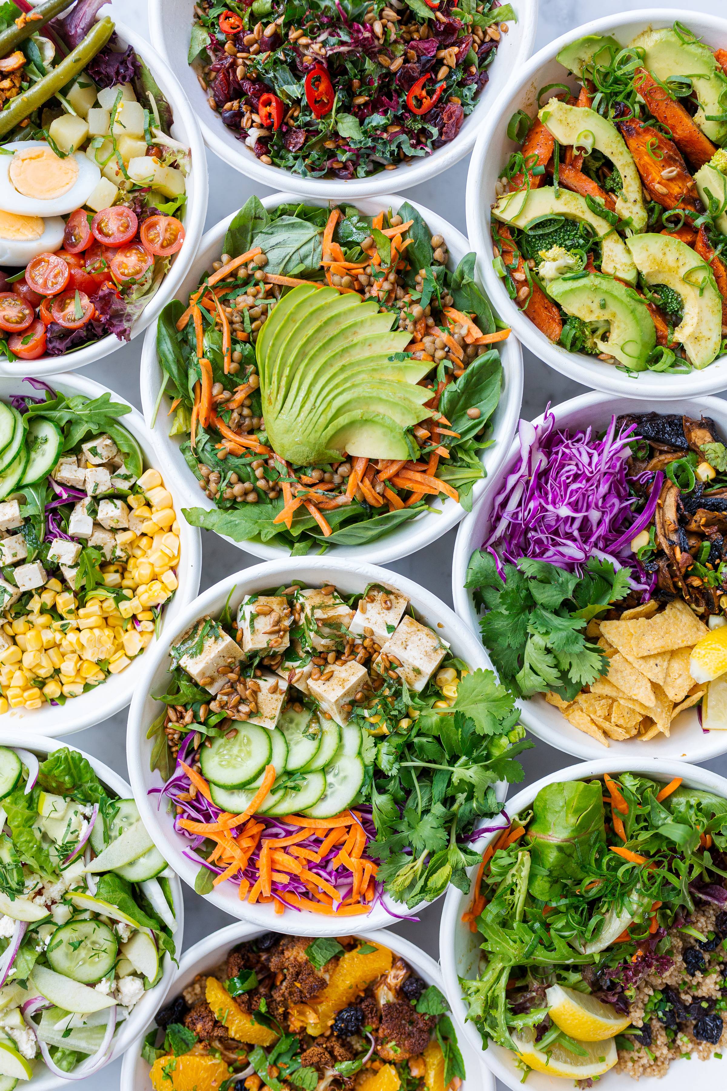 photo of bowls of salad, different varieties.