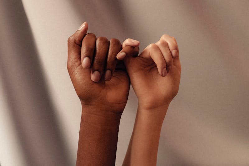 persons hand with white manicure