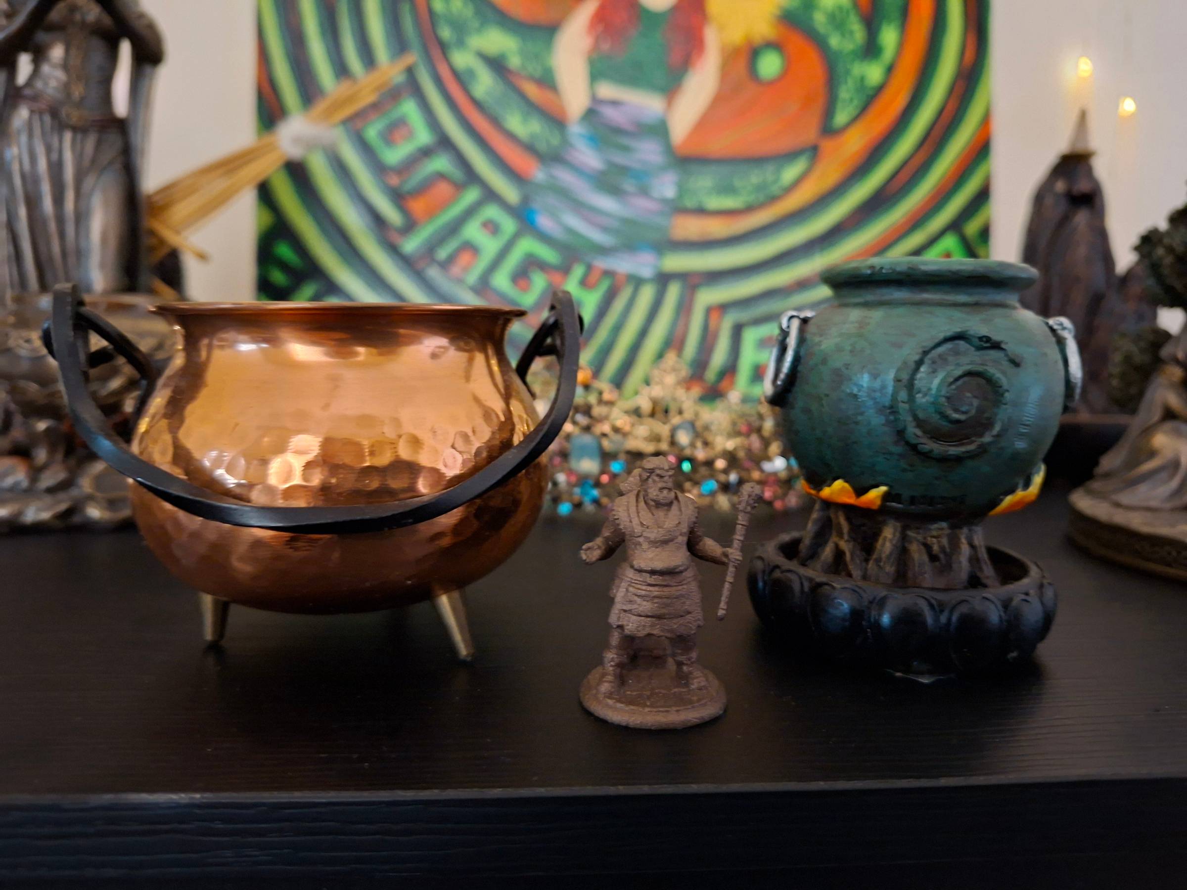 An image of my tiny Dagda statue with his two totally size appropriate cauldrons beside him!