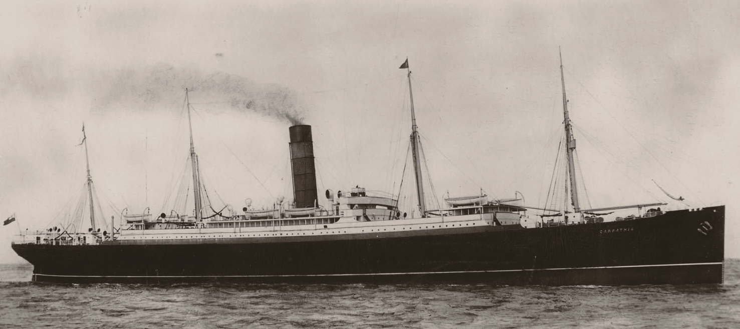 A black and white picture of the RMS Carpathia, with steam coming from her chimney and 4 sail masts evident to the lay eye