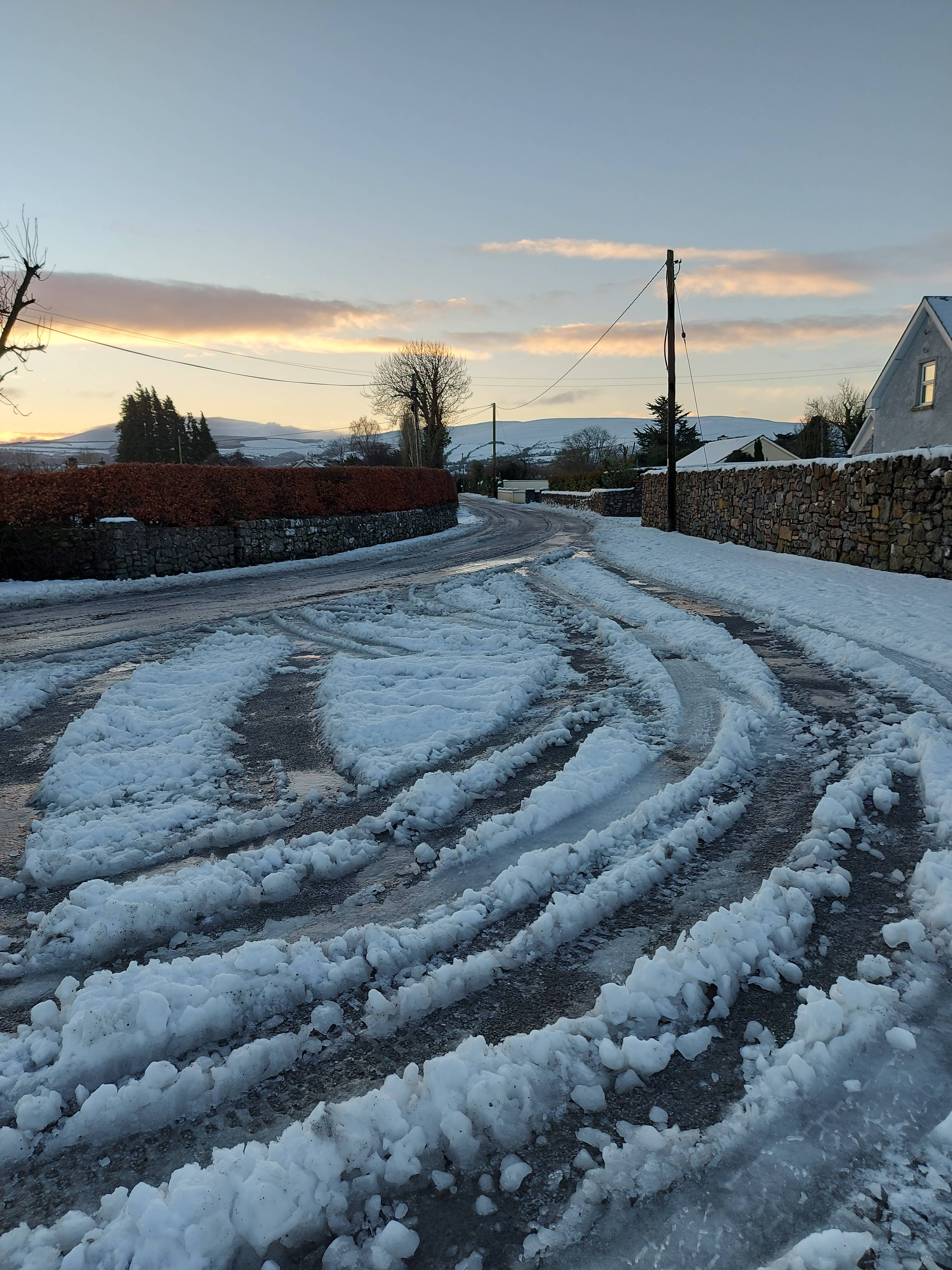 A pic of the road outside my house. It shows the snow on te edges with the road looking black but very shiny in places. All slippy. Basically a glorified ice rink!