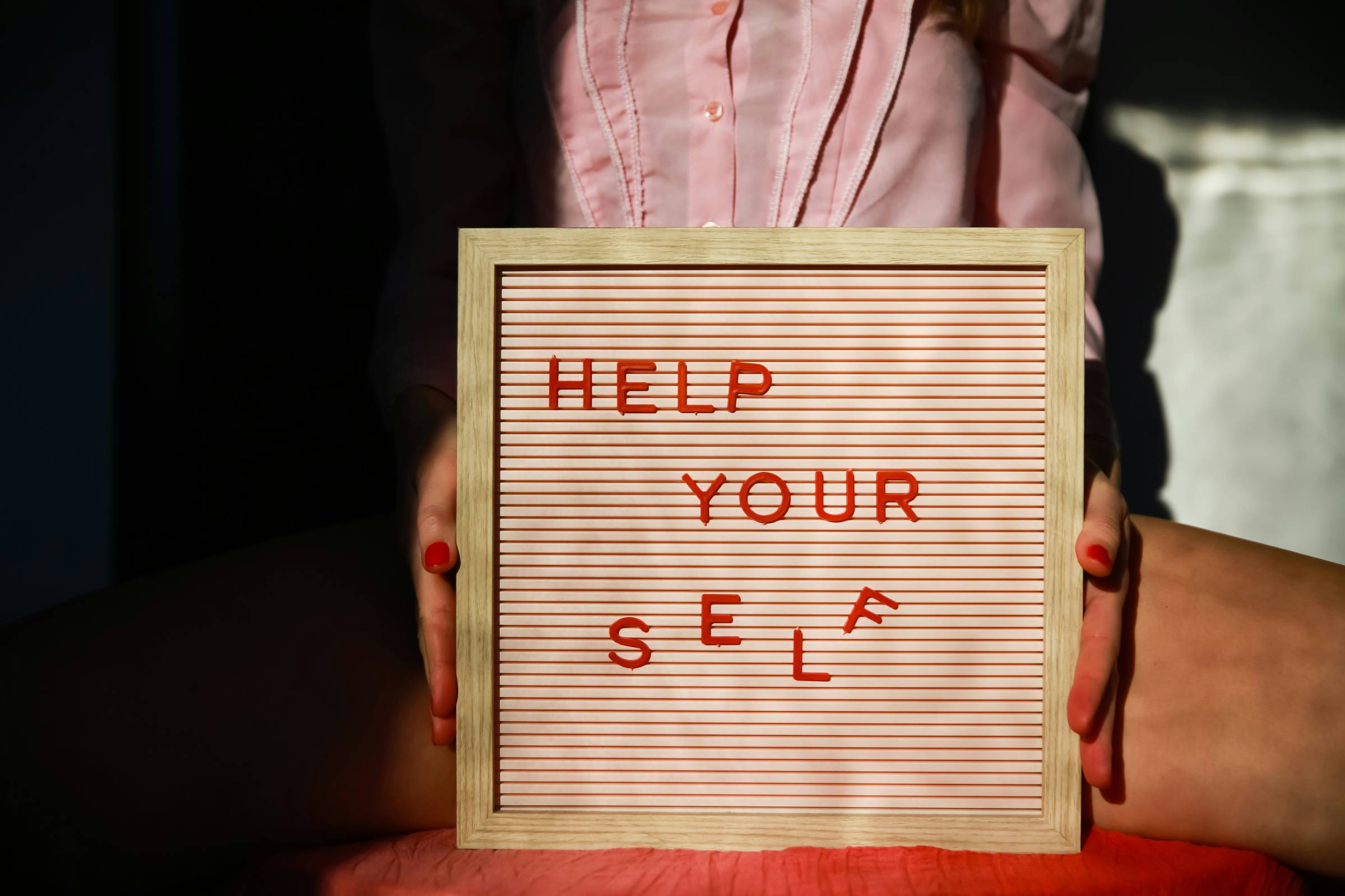 A sign saying "HELP YOUR SELF" with "self" a bit askew!