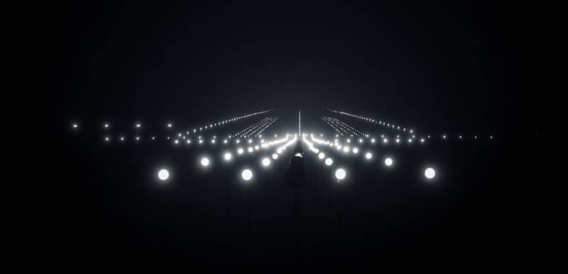 A black and white photo of a runway at night