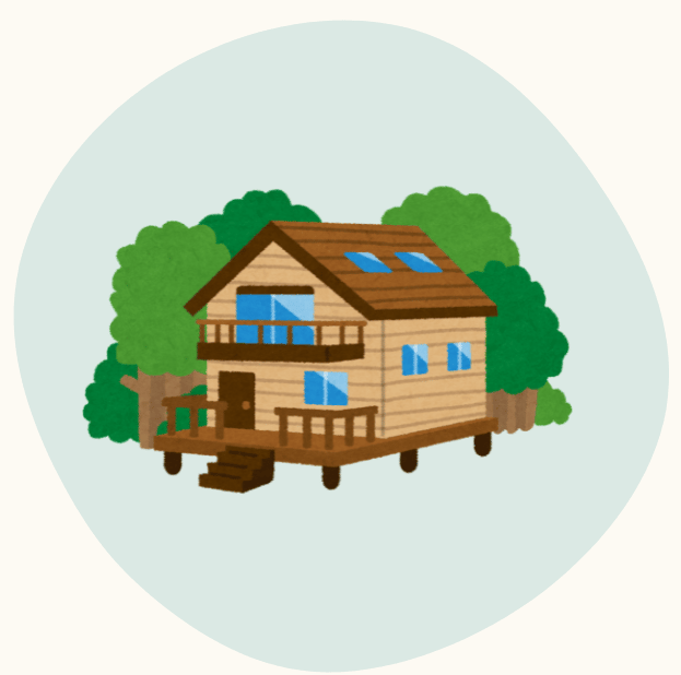 Small wooden cabin with porch and balcony, surrounded by trees.