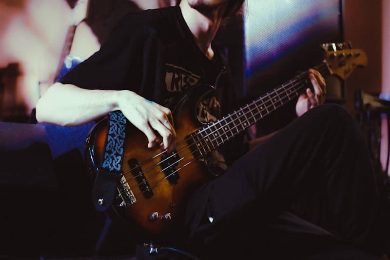 A man sitting on a couch playing a guitar