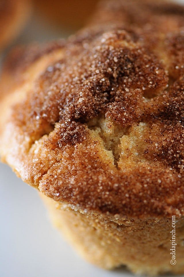 Closeup photograph of cinnamon apple muffins with cinnamon sugar coating. 