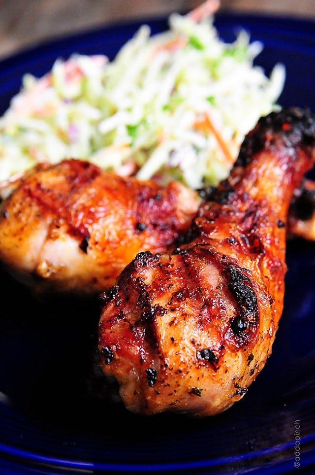 photograph of grilled chicken legs on a blue plate.