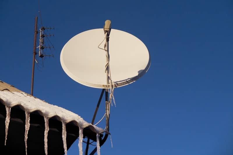 A satellite dish sitting on top of a roof