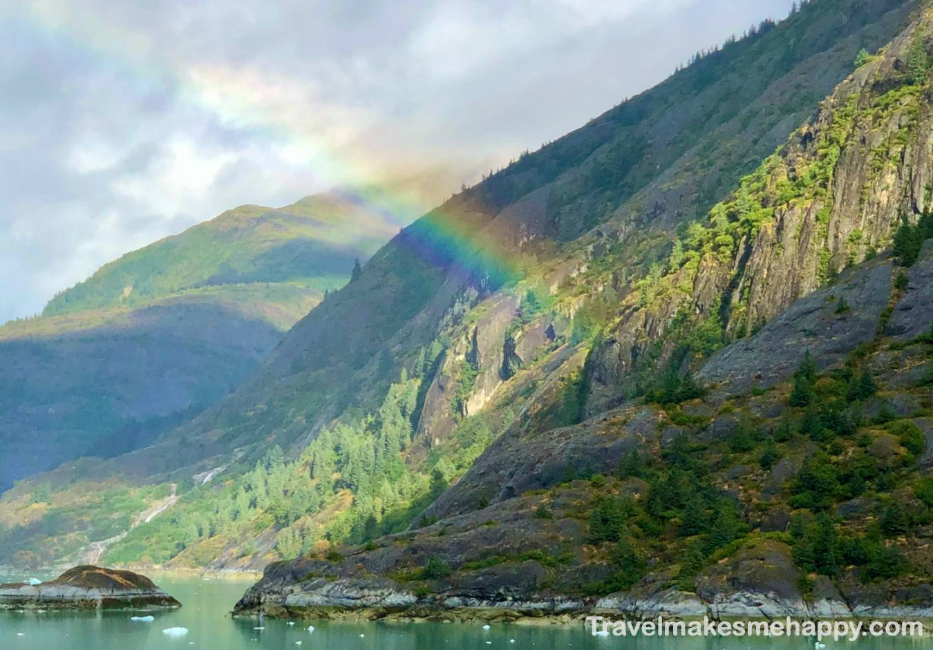 rainbow over alaska mountains on an Inside Passage cruise