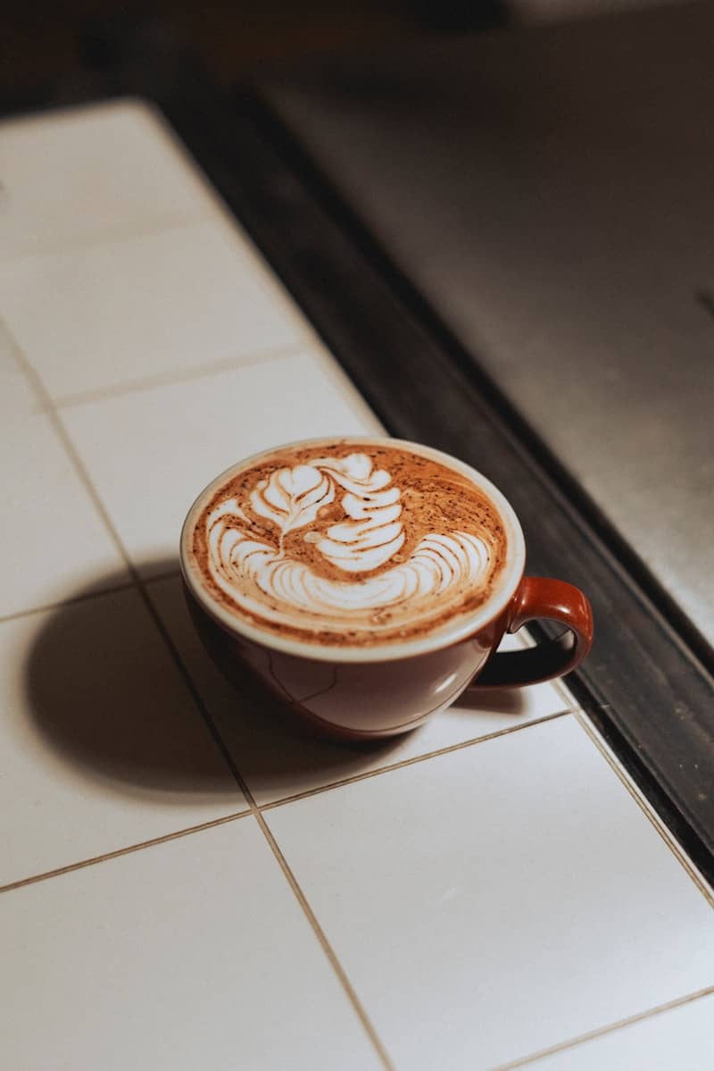 A cup of cappuccino on a tiled counter