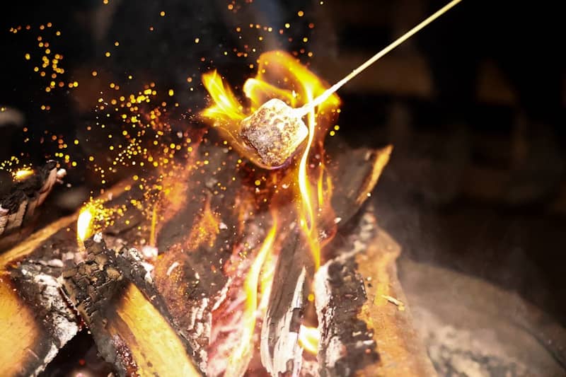 Marshmallow roasting over a warm campfire.