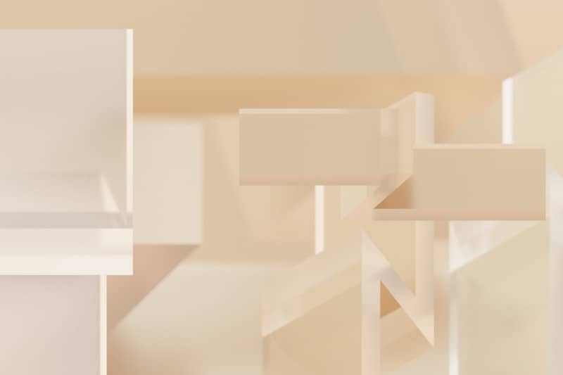 An abstract photo of a white shelf with a clock on it