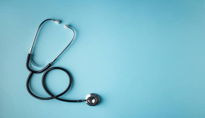 Stethoscope on blue background
