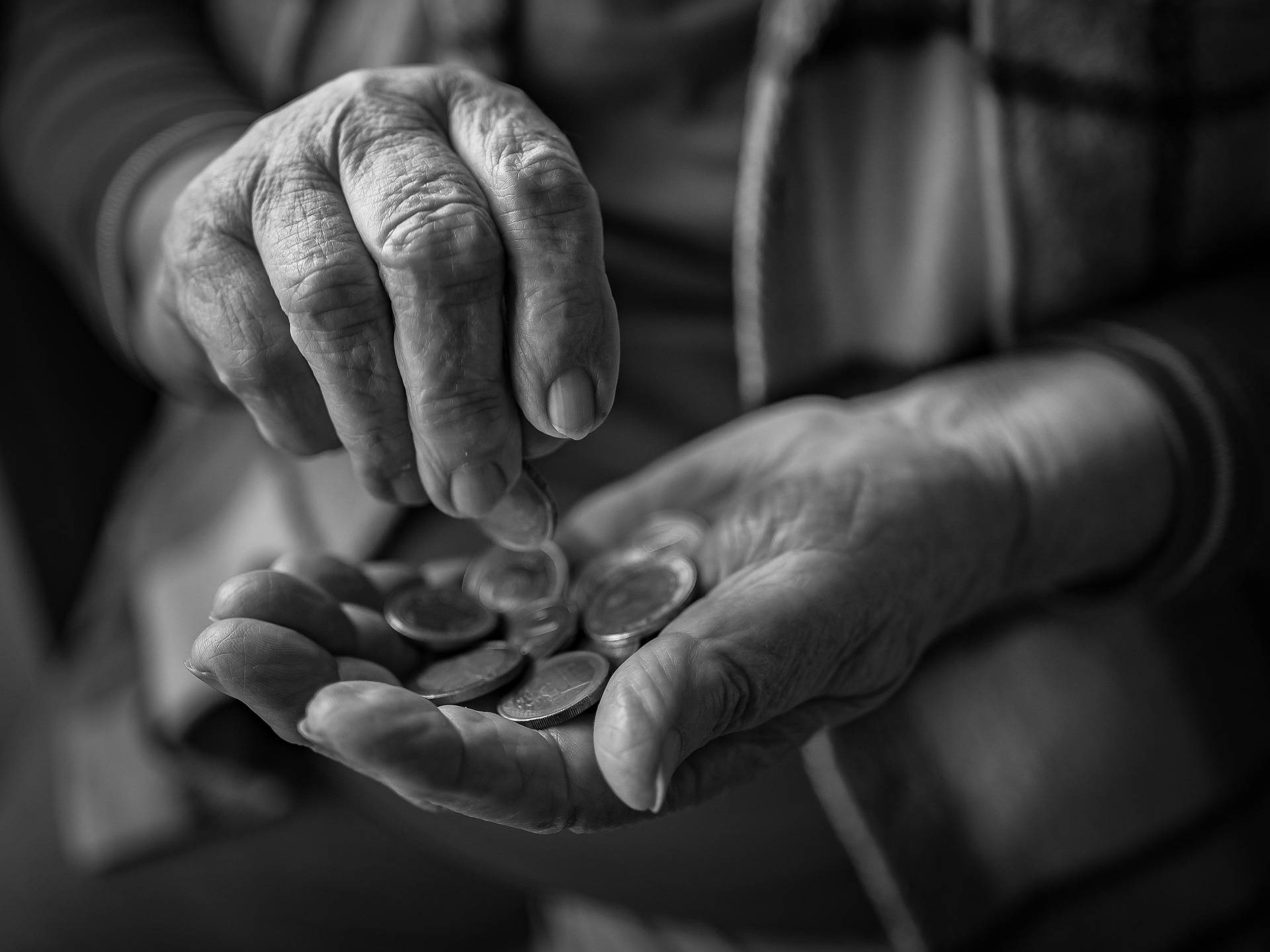 Old woman's hands holding coins