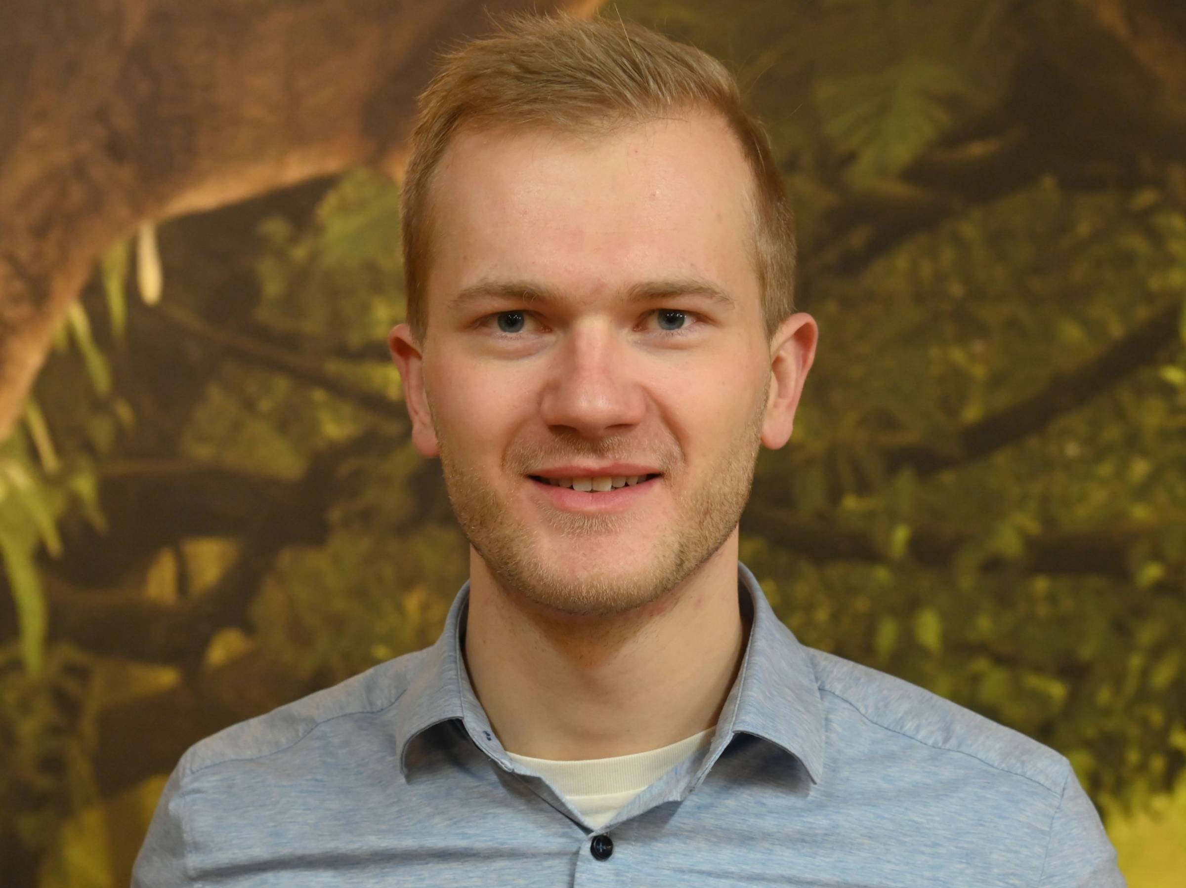 Tim in front of a forest background