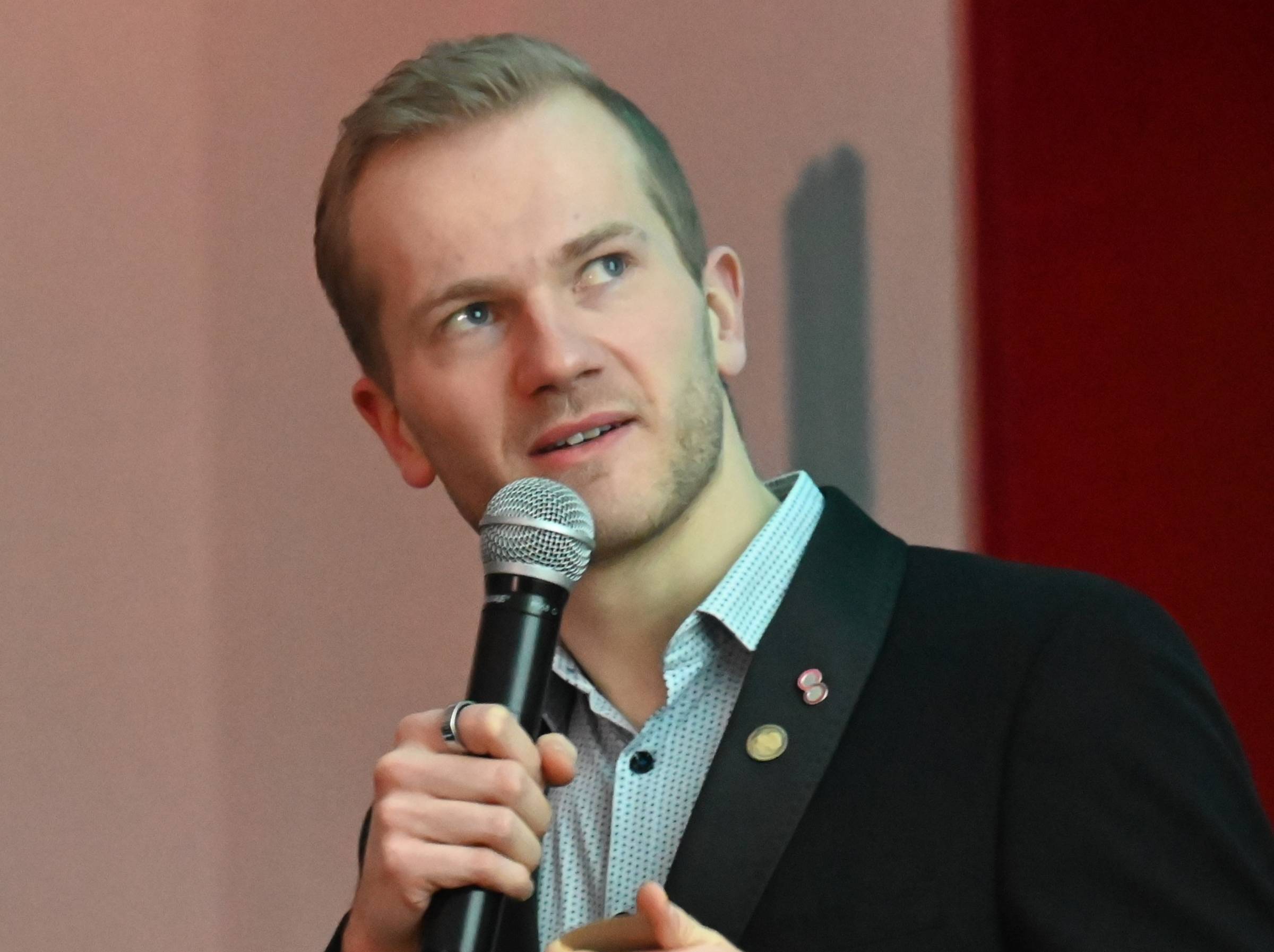 Tim presenting with a microphone