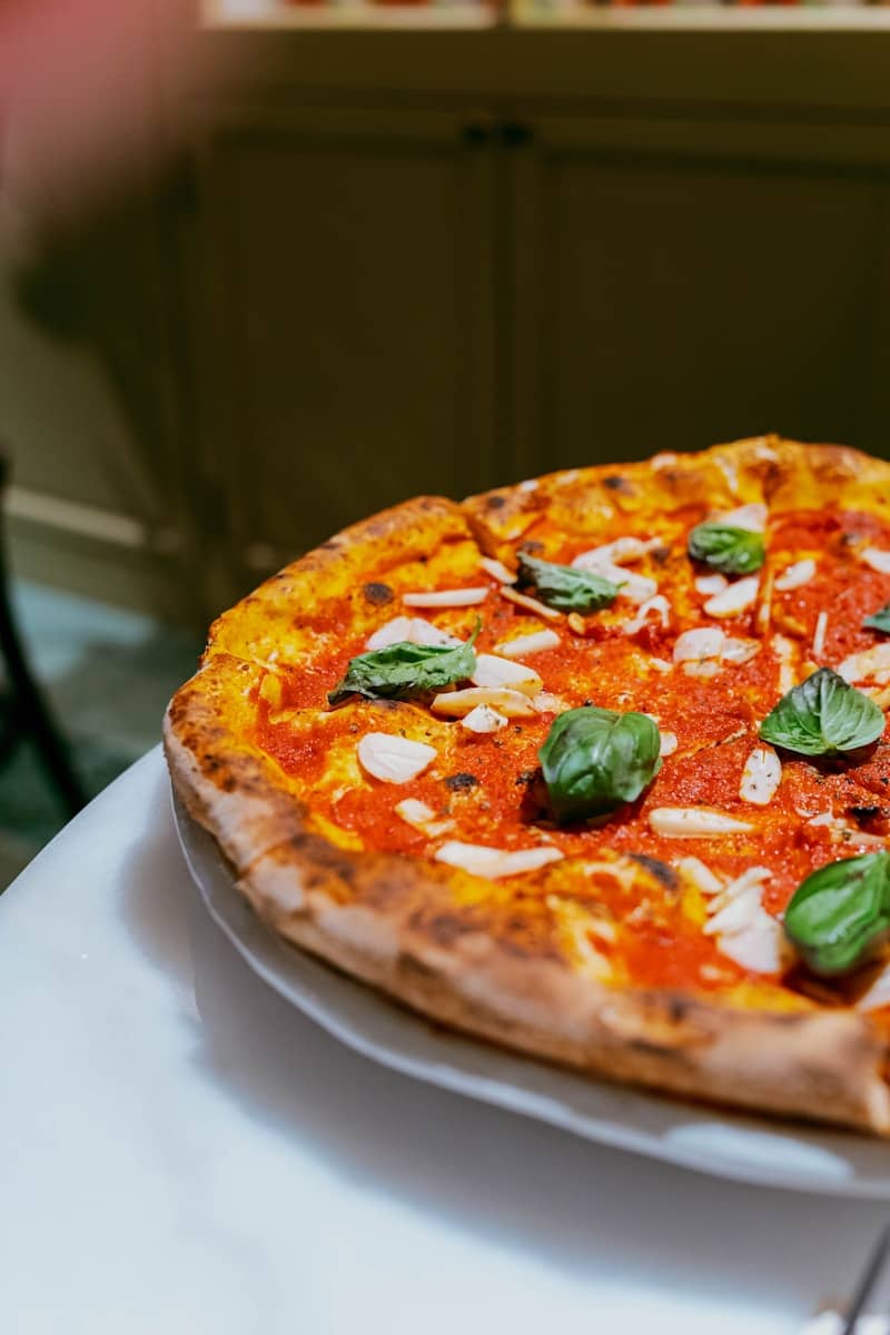 A delicious pizza with tomato sauce, cheese, and basil.