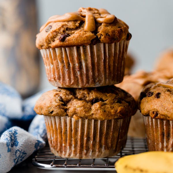 stack of two muffins, drizzles with peanut butter